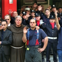 Father Michael Duffy leads firefighters in a benediction for Father Mychal Judge, the New York Fire Department chaplain, during the funeral for Judge in New York on Sept. 15, 2001. Judge died on Sept. 11, 2001, while administering last rites at the World Trade Center. | SUZANNE DECHILLO / THE NEW YORK TIMES