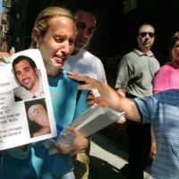 Michele Defazio is comforted by passersby as she distributes flyers bearing photos of her missing husband, Jason Defazio, in New York on Sept. 13, 2001. Jason Defazio worked as a bond trader at Cantor Fitzgerald on the 104th floor of the World Trade Center\'s north tower and was killed in the terror attack two days before. | KRISTA NILES / THE NEW YORK TIMES