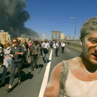 Joseph Sylvester (right) joins the exodus of people crossing the Brooklyn Bridge in New York after the collapse of the World Trade Center on Sept. 11, 2001. | ANDREA MOHIN / THE NEW YORK TIMES

