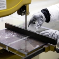 Emilie Beaudon, a postdoctoral scholar, cuts an ice core into samples to be tested at the Byrd Polar and Climate Research Center in Columbus, Ohio, on Jan. 15. | REUTERS
