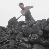 A worker shovels coal as he loads a truck at a coal port in Hanoi. | REUTERS 