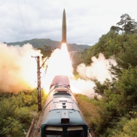 A railway-borne missile is test-fired in North Korea on Wednesday. | KCNA / KNS / VIA AFP-JIJI