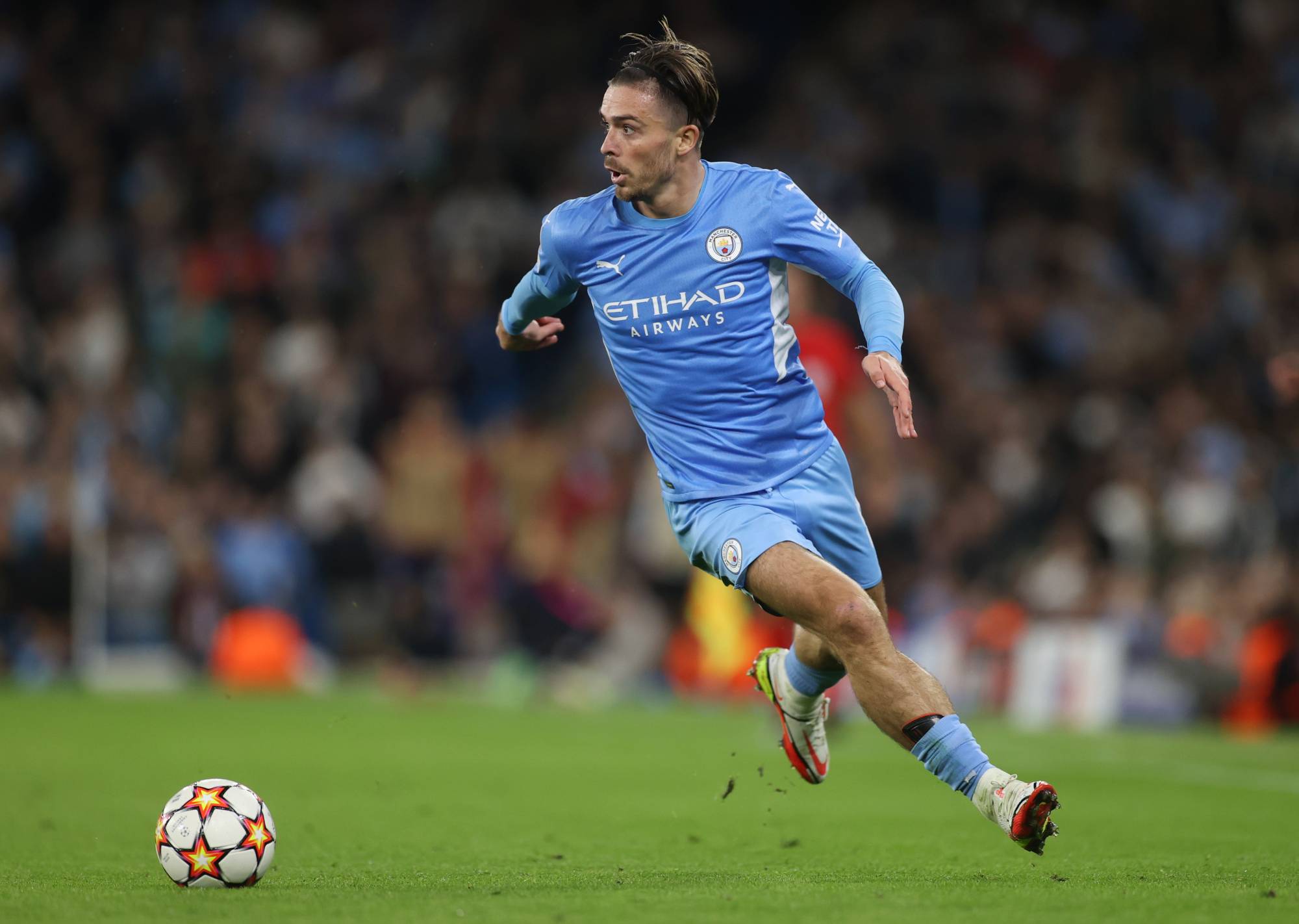 Manchester City's Jack Grealish moves with the ball during a Champions League match against Leipzig in Manchester, England, on Wednesday. | ACTION IMAGES / VIA REUTERS