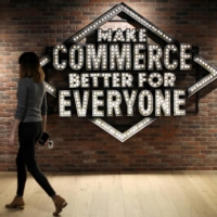 An employee walks past a sign at Shopify\'s headquarters in Ottawa in October 2018. | REUTERS