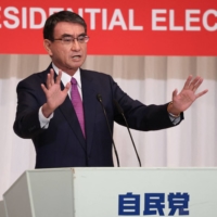 Vaccine chief Taro Kono delivers a campaign speech in Tokyo on Friday. | POOL / AFP-JIJI