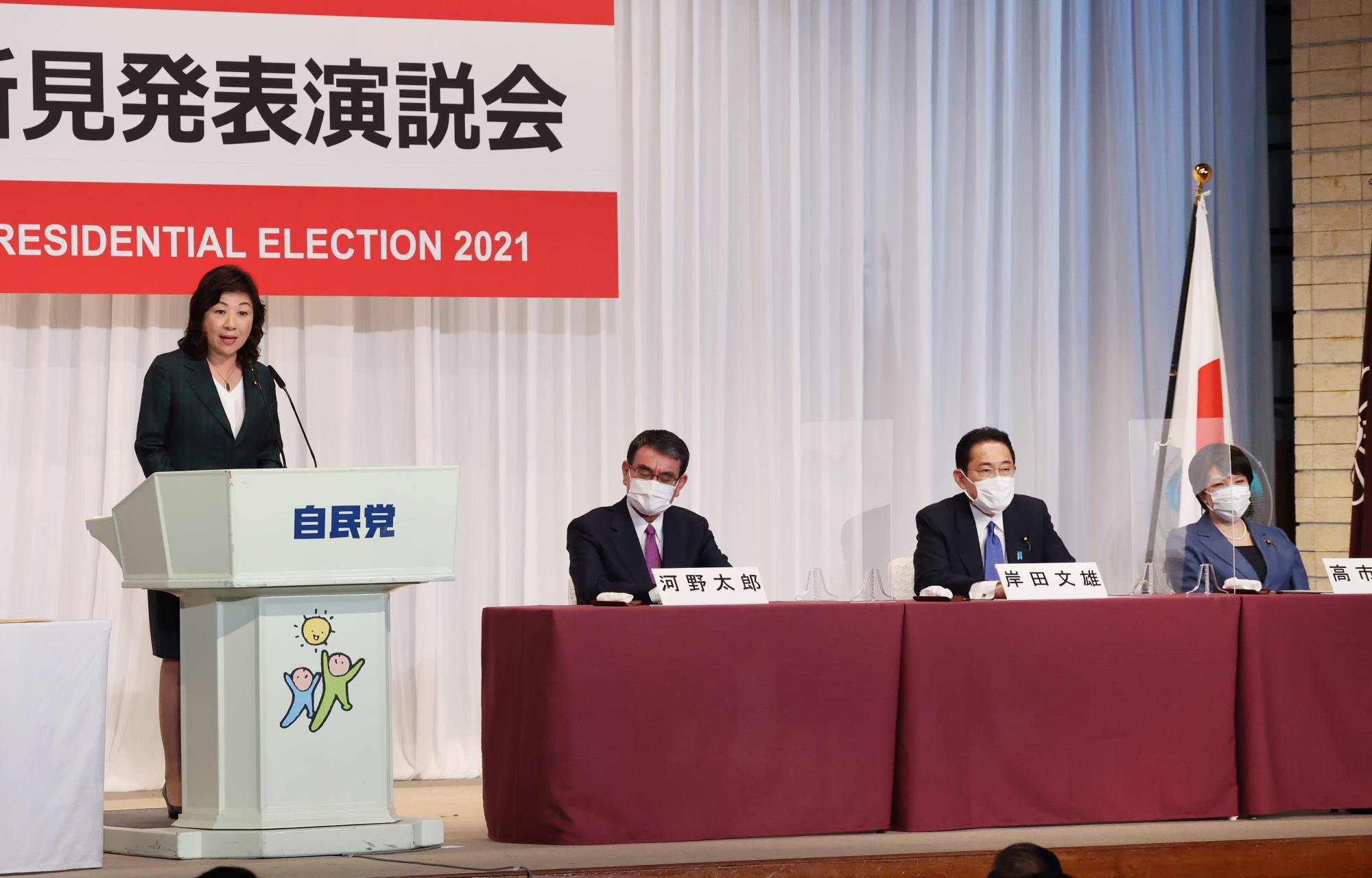 Seiko Noda, former communications minister of Japan, delivers her campaign speech for the Liberal Democratic Party's presidential election as other candidates look on in Tokyo on Friday. | BLOOMBERG
