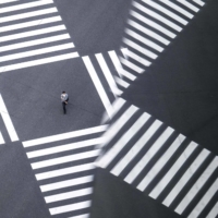 A pedestrian crosses a street in Tokyo on Thursday.  | AFP-JIJI