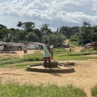 A resident uses the single water pump in Butawu, Liberia. | BLOOMBERG 