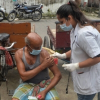 A health worker administers a dose of a COVID-19 vaccine at a camp in Siliguri, India, on Sunday.  | AFP-JIJI