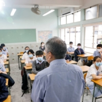 A teacher introduces himself during the first day of the new term in Hong Kong on Sept. 1. | REUTERS 