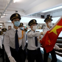 Secondary school students march with the Chinese national flag for a ceremony during the first day of the new term in Hong Kong on Sept. 1.  | REUTERS 