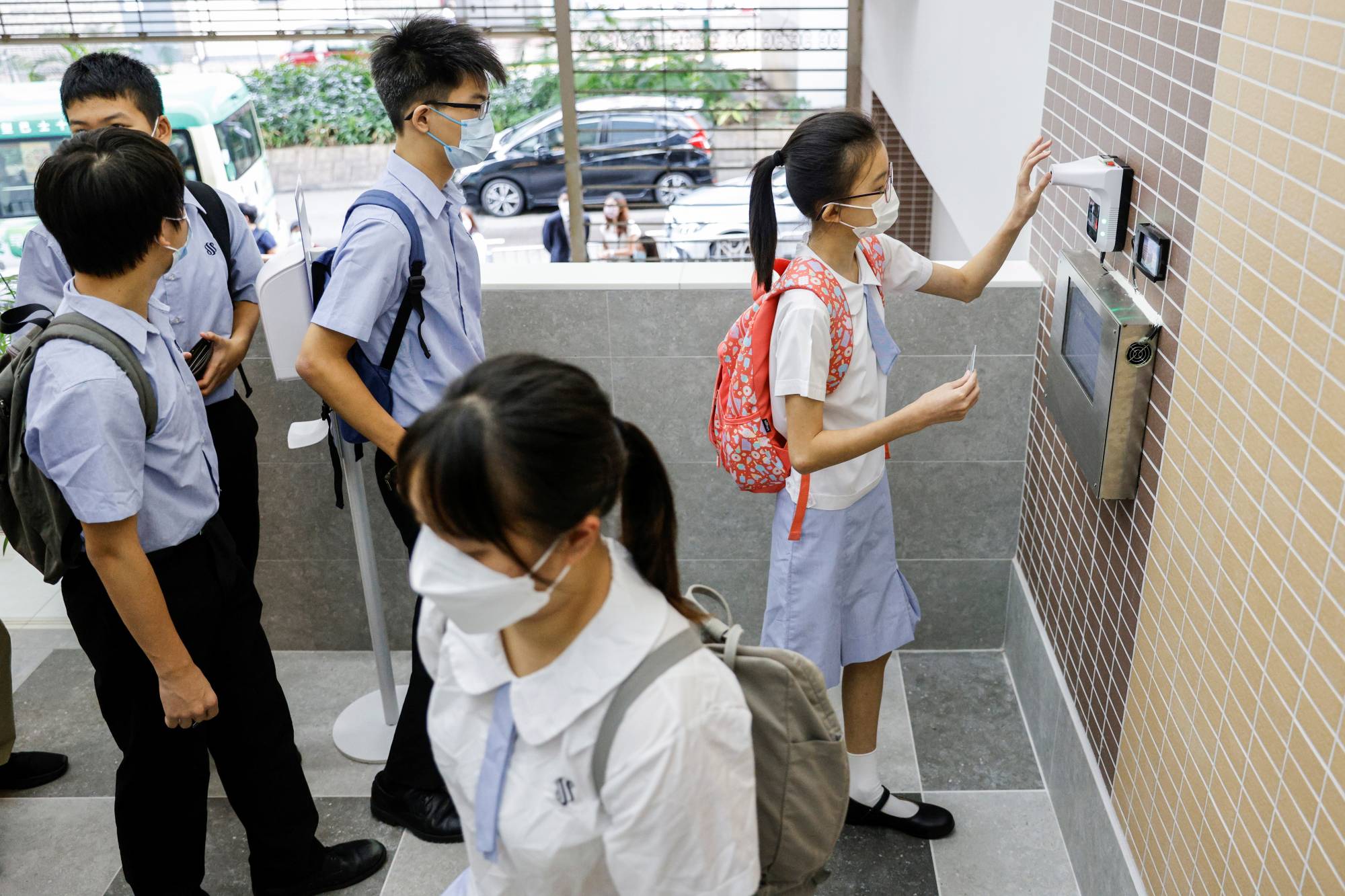 Students have their temperatures checked in Hong Kong. | Reuters 