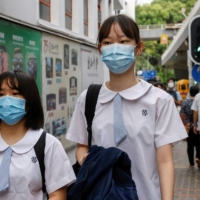 Students arrive for the first day of the new term in Hong Kong on Sept. 1.  | REUTERS 