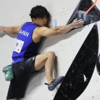 Kokoro Fujii tackles a bouldering problem during the world championships in Moscow on Sunday. | AP / VIA KYODO