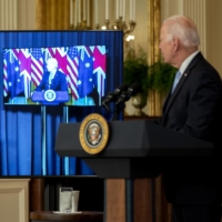 U.S. President Joe Biden listens as Scott Morrison, Australia\'s prime minister, speaks via videoconference in the East Room of the White House in Washington on Wednesday.  | BLOOMBERG 