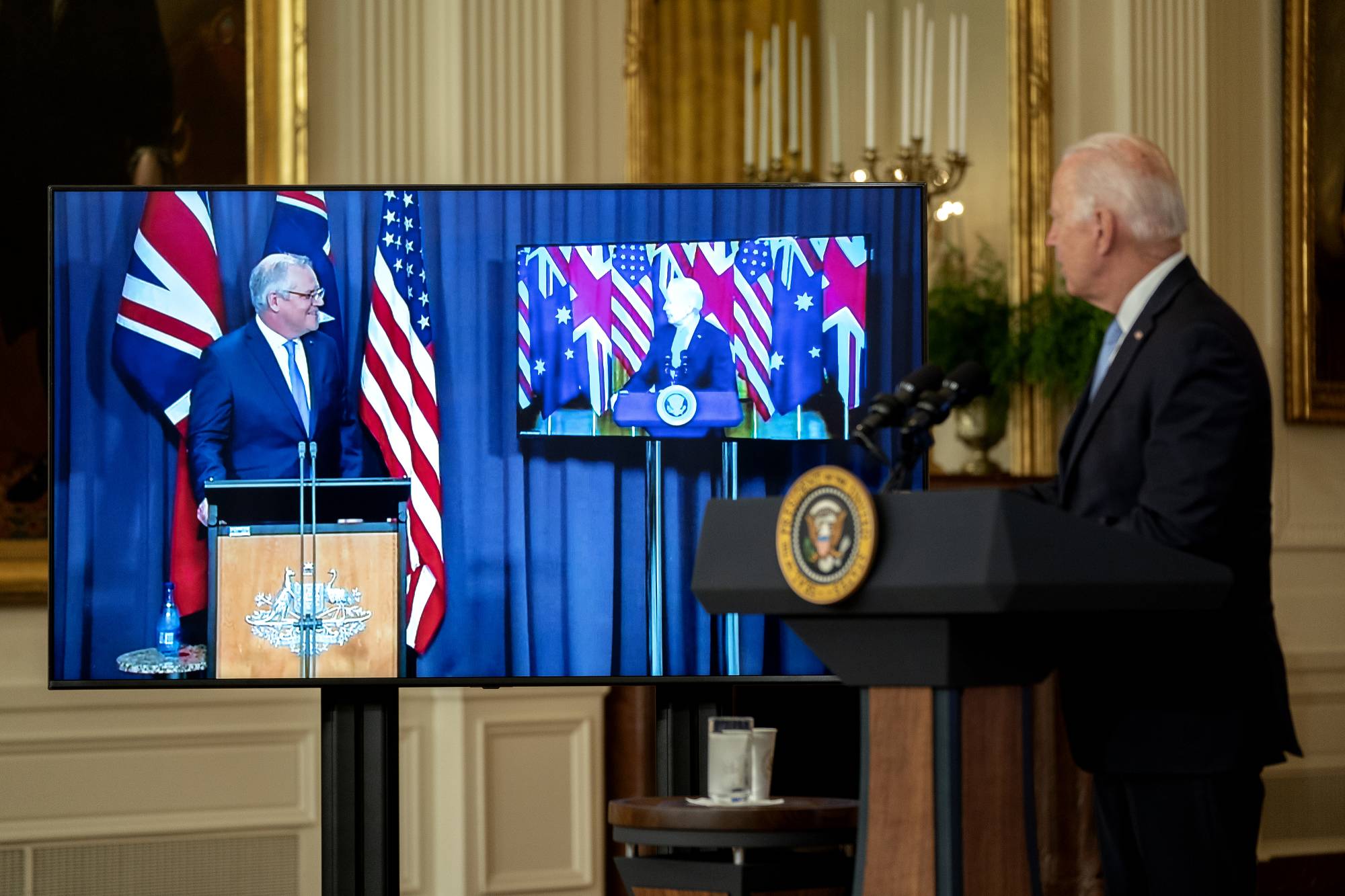 U.S. President Joe Biden listens as Scott Morrison, Australia's prime minister, speaks via videoconference in the East Room of the White House in Washington on Wednesday.  | BLOOMBERG 