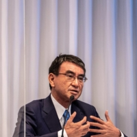 Vaccine rollout minister Taro Kono says COVID-19 booster shots for older people will begin early next year. | POOL / VIA BLOOMBERG