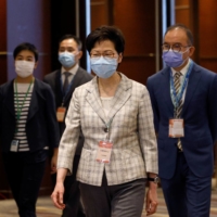 Hong Kong Chief Executive Carrie Lam visits a polling station during voting for the election committee on Sunday. | REUTERS
