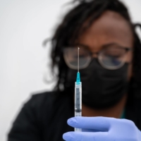 A medical worker prepares a dose of the Pfizer-BioNTech vaccine in San Francisco on Aug. 1. After weeks of internal strife at the U.S. Food and Drug Administration, the agency on Wednesday authorized people over 65 who had received Pfizer-BioNTech\'s coronavirus vaccine to get a booster shot at least six months after their second injection. | MIKE KAI CHEN / THE NEW YORK TIMES