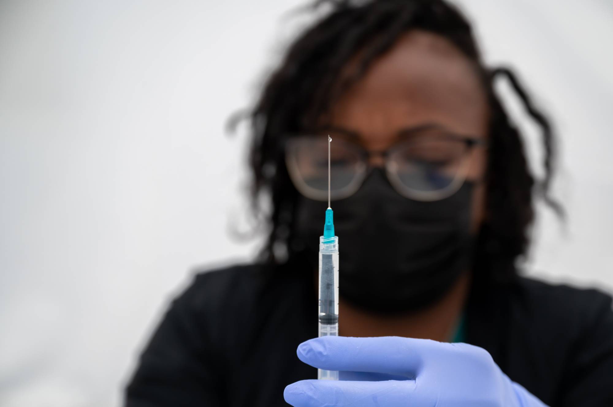 A medical worker prepares a dose of the Pfizer-BioNTech vaccine in San Francisco on Aug. 1. After weeks of internal strife at the U.S. Food and Drug Administration, the agency on Wednesday authorized people over 65 who had received Pfizer-BioNTech's coronavirus vaccine to get a booster shot at least six months after their second injection. | MIKE KAI CHEN / THE NEW YORK TIMES