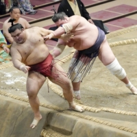 Takayasu is shoved off the ring by Terunofuji at Ryogoku Kokugikan on Wednesday. | KYODO