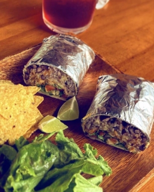 Home Taco Bar’s burritos are filled with jasmine rice, black beans, smoked meat and fresh, local lettuce. | © HOME TACO BAR 