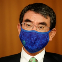 Taro Kono is often seen sporting a Shonan Bellmare mask. | REUTERS