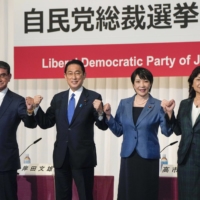 The Liberal Democratic Party\'s presidential candidates, from left, Taro Kono, Fumio Kishida, Sanae Takaichi and Seiko Noda pose for a photo during a news conference at the party\'s headquarters in Tokyo on Sept. 17. | POOL / VIA BLOOMBERG