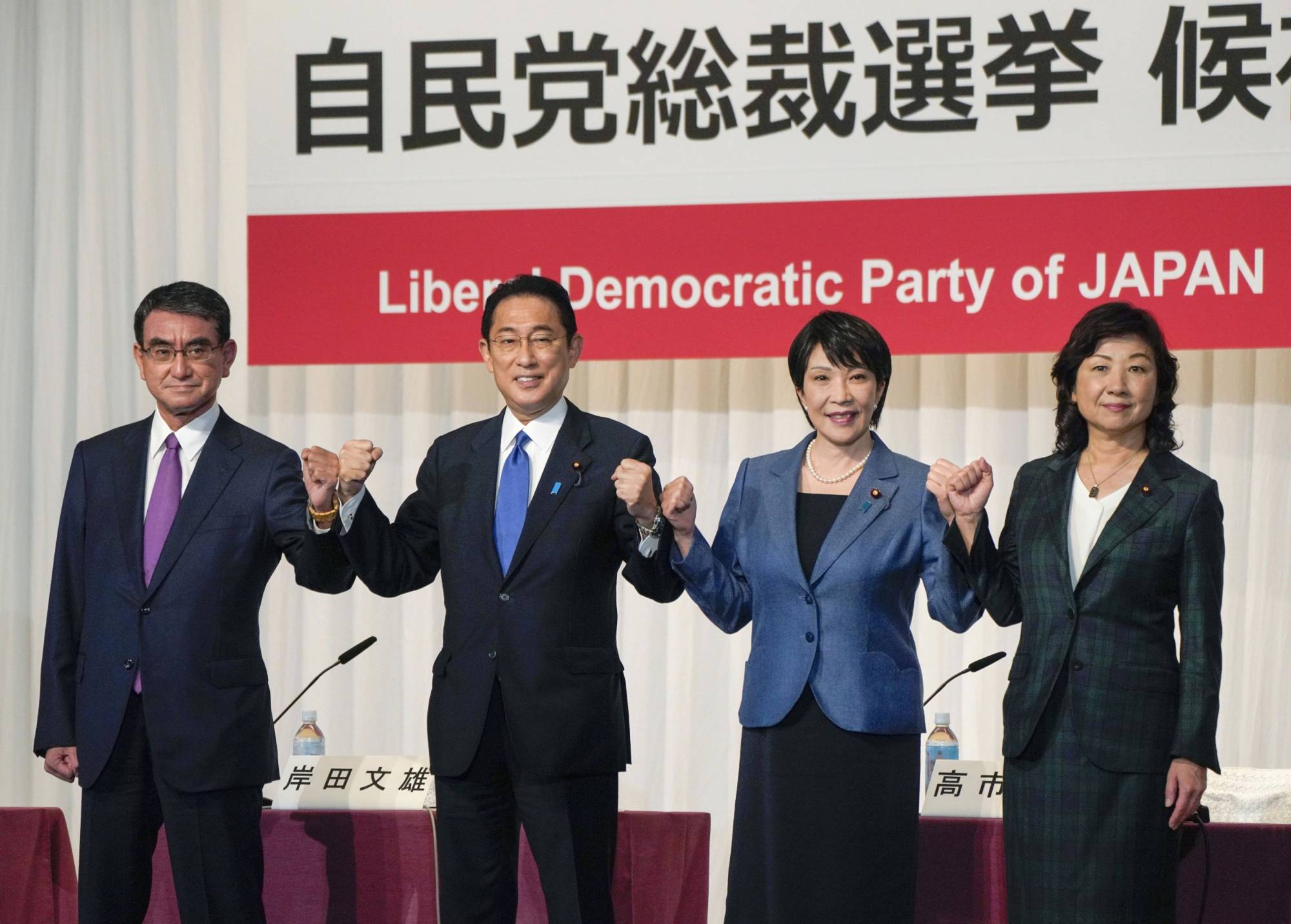 The Liberal Democratic Party's presidential candidates, from left, Taro Kono, Fumio Kishida, Sanae Takaichi and Seiko Noda pose for a photo during a news conference at the party's headquarters in Tokyo on Sept. 17. | pool / via Bloomberg