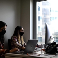 Two women work at a co-working office in Paris in October last year. | AFP-JIJI