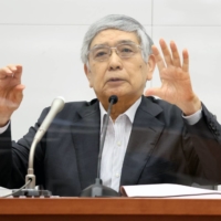 Bank of Japan Gov. Haruhiko Kuroda speaks during a news conference in Tokyo on Monday. | POOL / VIA BLOOMBERG