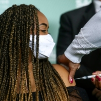 A teenager receives a dose of Sinovac\'s COVID-19 vaccine in Sao Paulo in August.  | REUTERS