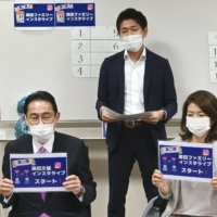 Fumio Kishida appears with his wife, Yuko, and their eldest son, Shotaro (in the back), filming for Instagram live on Sept. 20 while campaigning for the Liberal Democratic Party\'s presidential election. | KYODO
