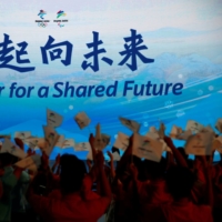 The Beijing 2022 Winter Olympics slogan, \"Together for a shared future,\" is unveiled in Beijing. China has asked Japan for support on holding the Games during the COVID-19 crisis.  | REUTERS