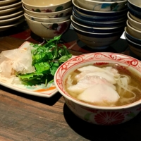 An Com’s pho noodles come in a clear-golden chicken broth and are topped with slices of pure white breast meat, with a wedge of lime and plenty of aromatic herbs on the side. | ROBBIE SWINNERTON
