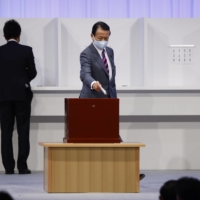 Taro Aso, deputy prime minister and finance minister, casts his ballot during the Liberal Democratic Party\'s (LDP) leadership election in Tokyo on Wednesday. | BLOOMBERG