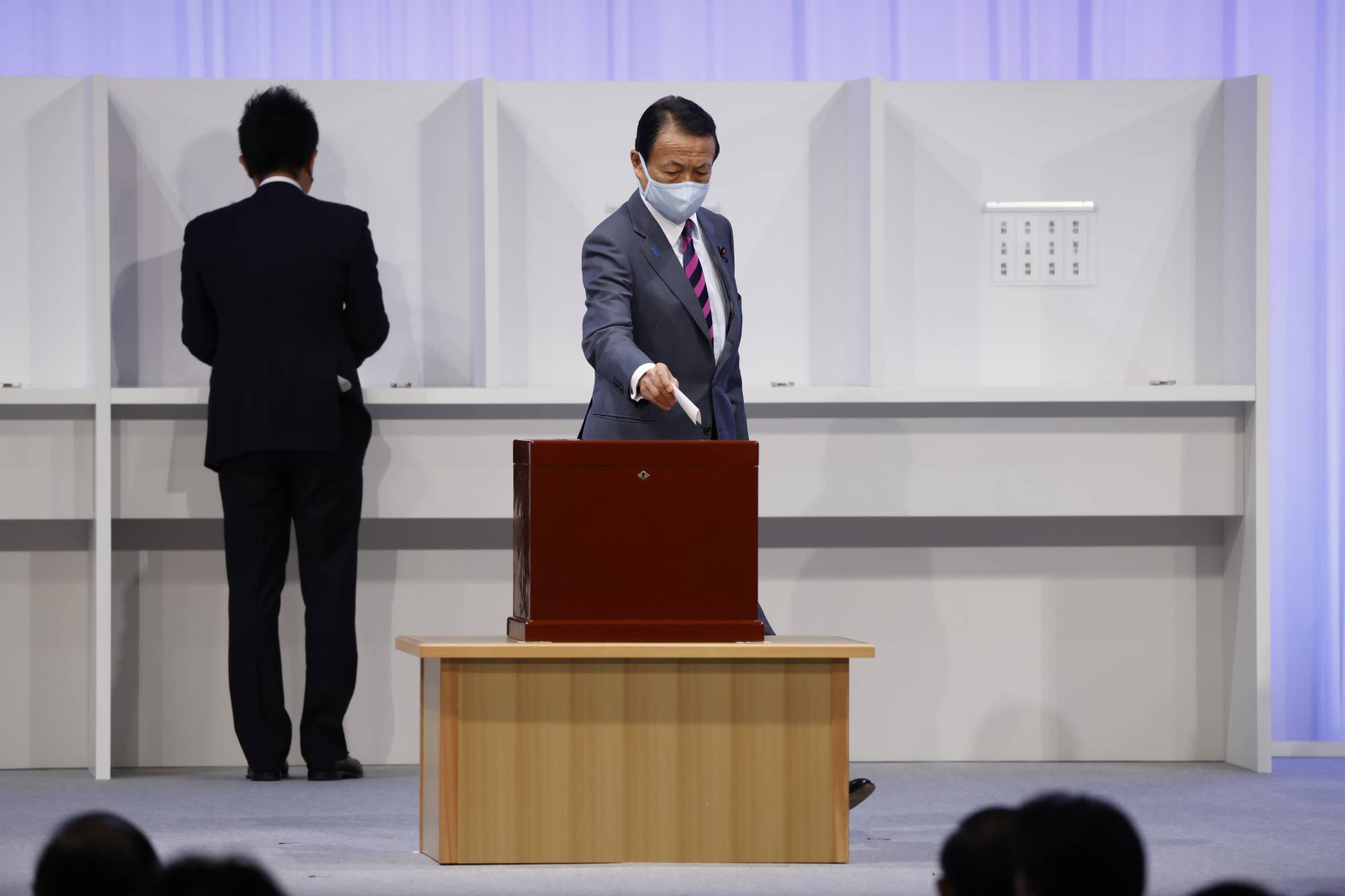 Taro Aso, deputy prime minister and finance minister, casts his ballot during the Liberal Democratic Party's (LDP) leadership election in Tokyo on Wednesday. | Bloomberg