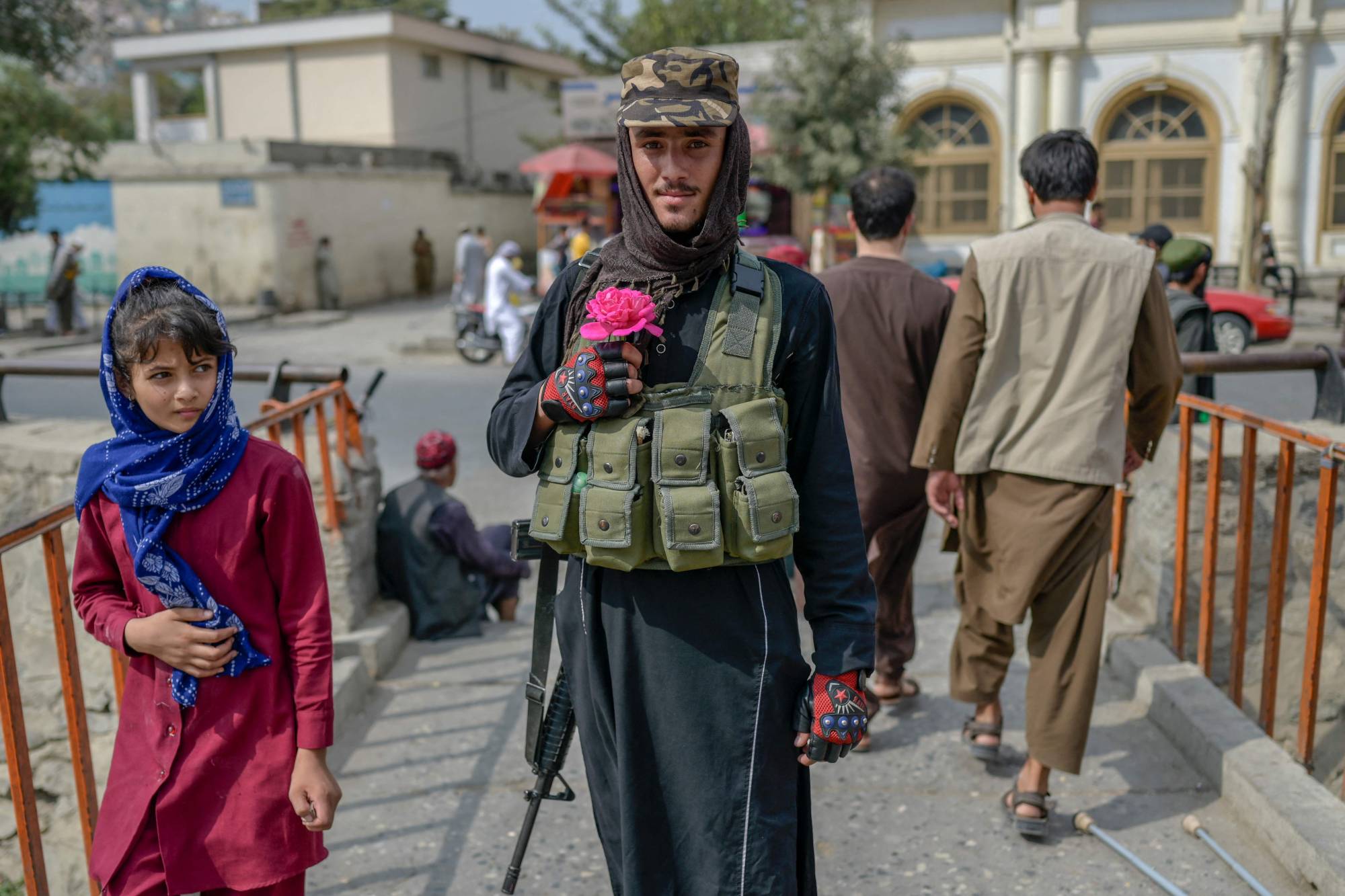 A Taliban fighter poses for a picture holding a flower before offering prayers in Kabul on Friday. | AFP-JIJI