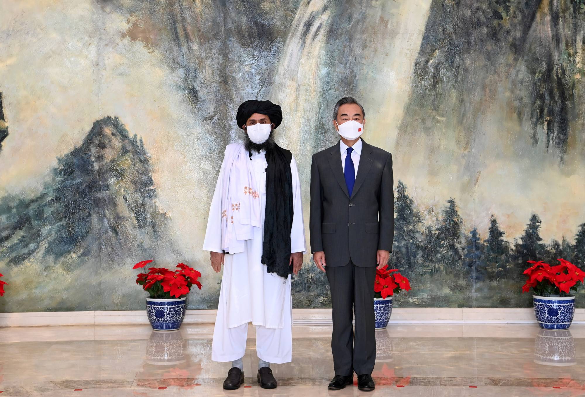 Mullah Abdul Ghani Baradar, political chief of the Taliban, meets with Chinese State Councilor and Foreign Minister Wang Yi in Tianjin, China, on July 28. | XINHUA / VIA REUTERS