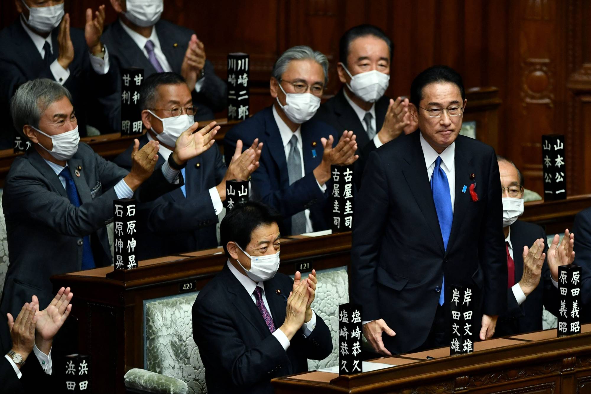 Liberal Democratic Party President Fumio Kishida is applauded after being elected prime minister in the Lower House in Tokyo on Monday. | AFP-JIJI