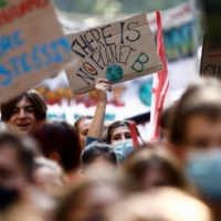 People take part in a march for climate justice in Milan.  | REUTERS