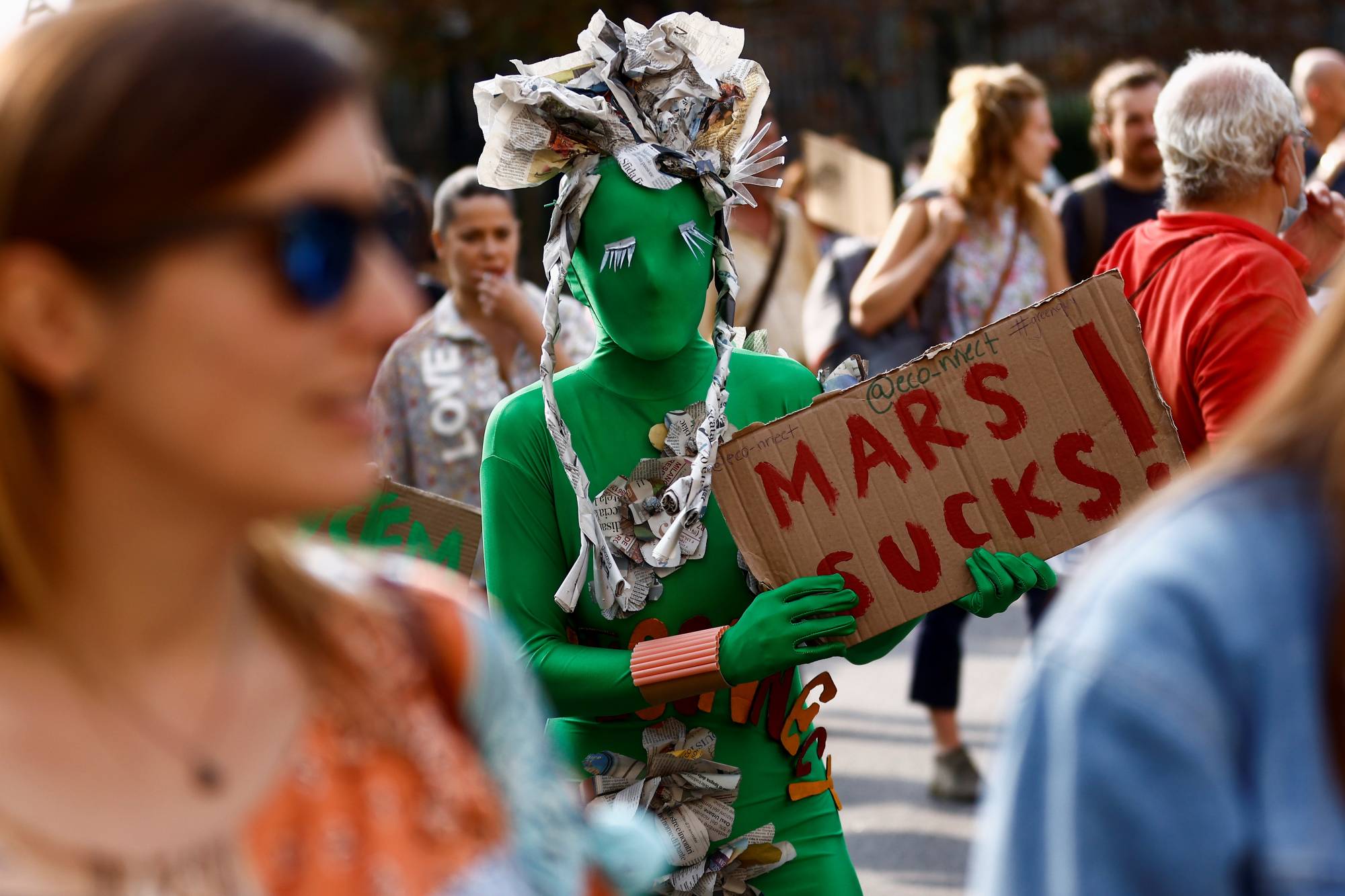 A costumed protester at a climate march in Milan | Reuters