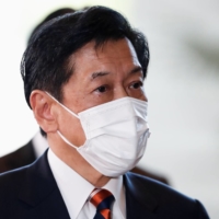 Environment Minister Tsuyoshi Yamaguchi arrives at the Prime Minister\'s Office in Tokyo on Monday. | REUTERS