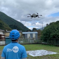 An Aeronext Inc. staff monitors a drone taking off in Kosuge Village, Yamanashi Prefecture.  | COURTESY OF AERONEXT
