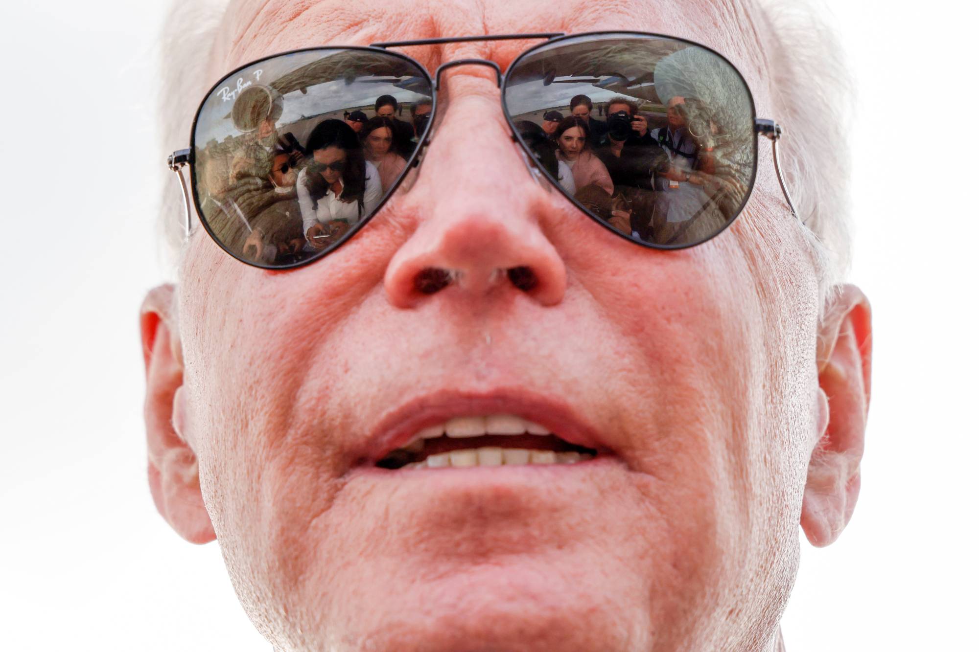 U.S. President Joe Biden speaks to reporters before boarding Air Force One in Lansing, Michigan, on Tuesday. | REUTERS