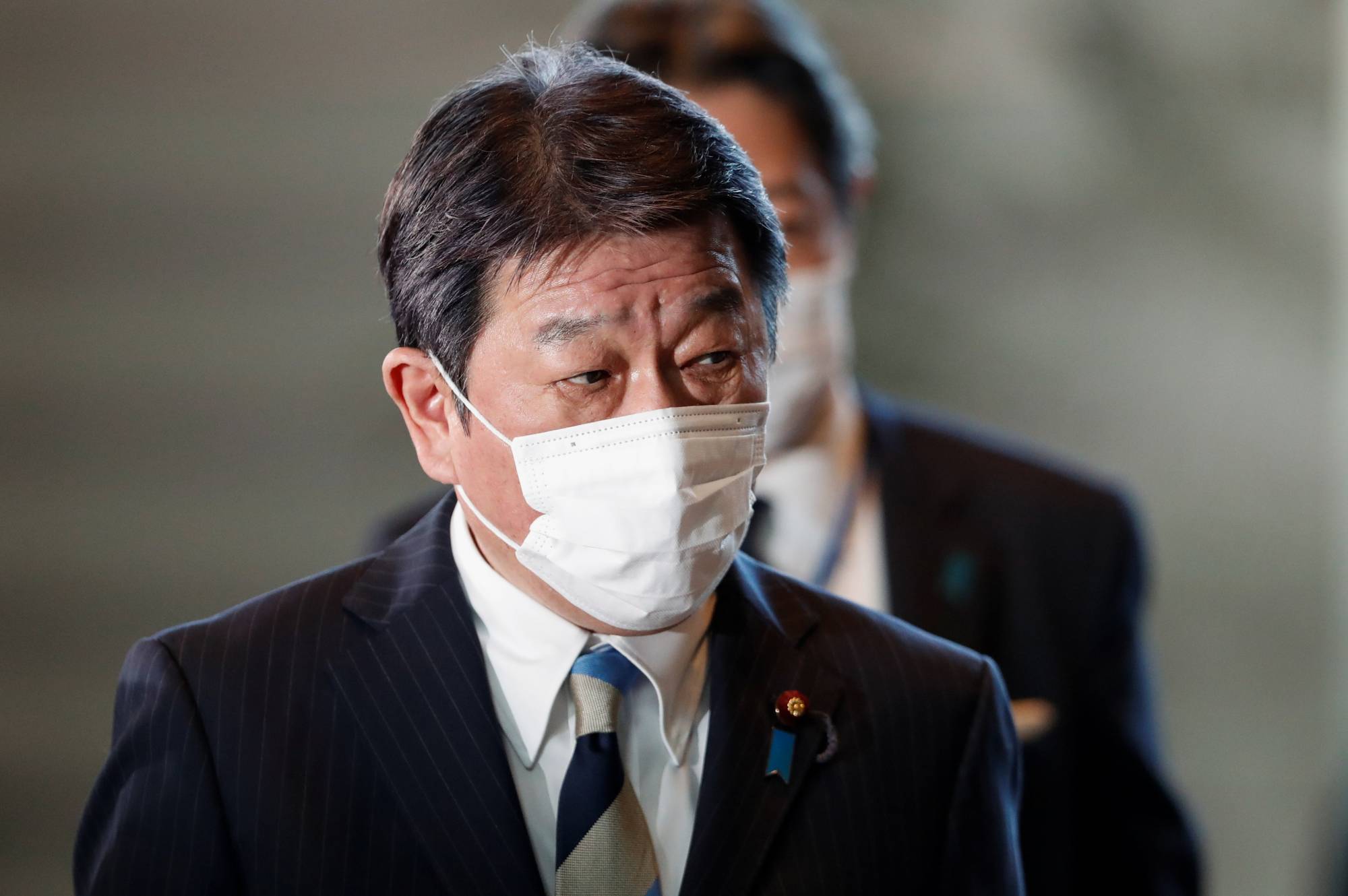 Foreign Minister Toshimitsu Motegi arrives at the Prime Minister's Office in Tokyo on Monday. | REUTERS