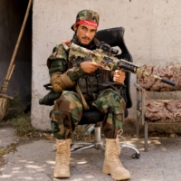 A Taliban soldier sits outside a news conference in Kabul on Oct. 5. | REUTERS