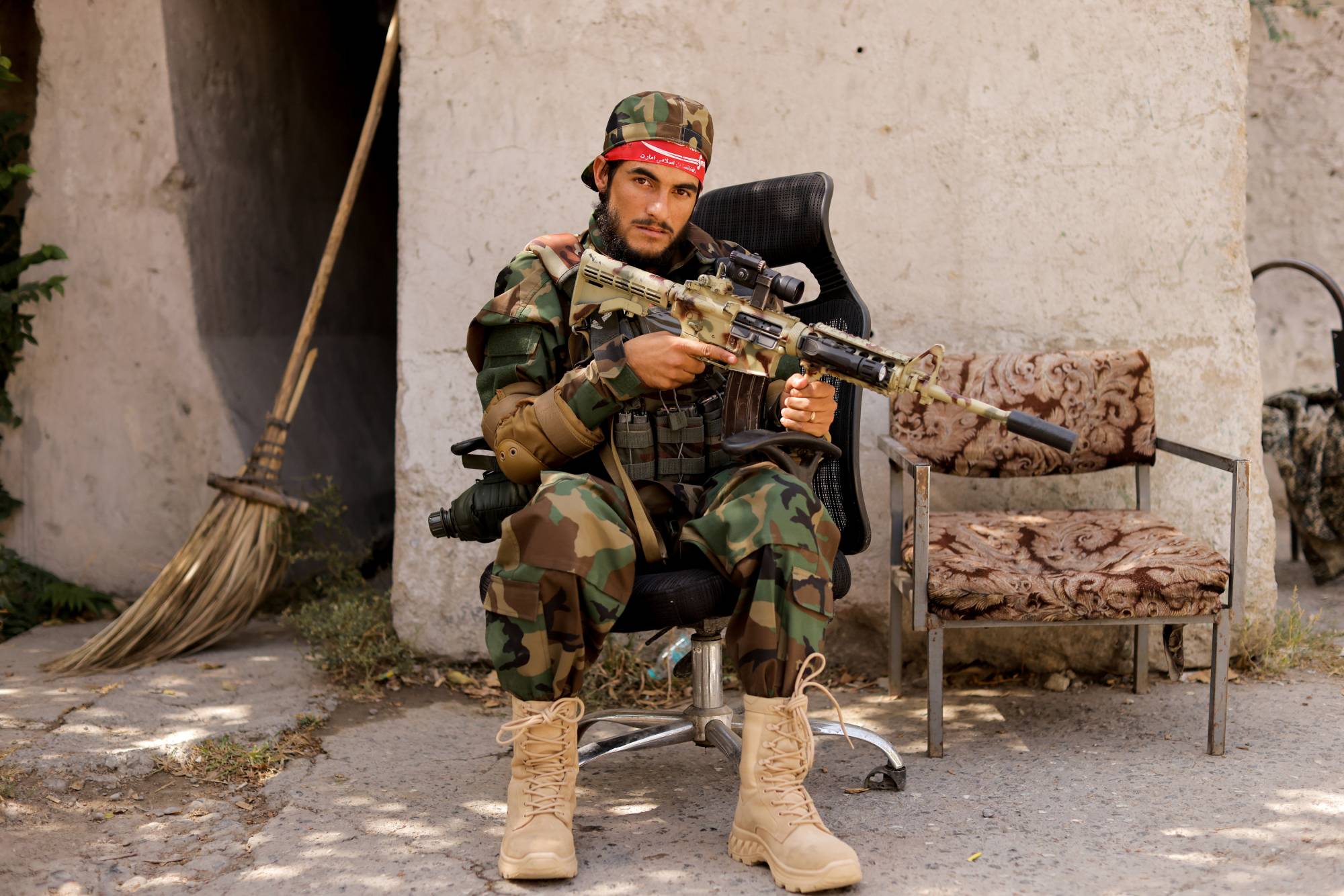 A Taliban soldier sits outside a news conference in Kabul on Oct. 5. | REUTERS