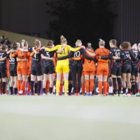 Members of the Thorns and Dash link arms at the six-minute mark of their match at Providence Park, in Portland, Oregon, on Wednesday. | USA TODAY / VIA REUTERS