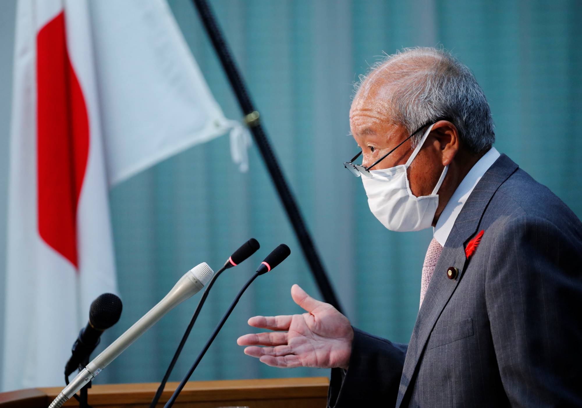 Finance Minister Shunichi Suzuki speaks at a news conference in Tokyo on Tuesday. | REUTERS
